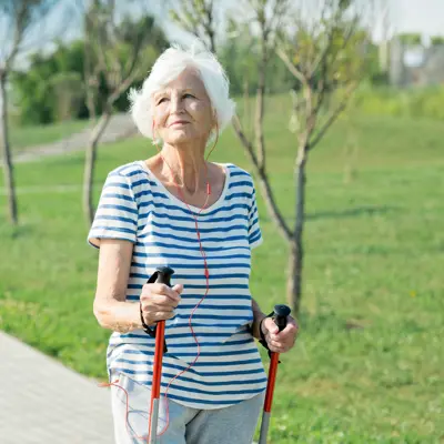 senior using Nordic poles