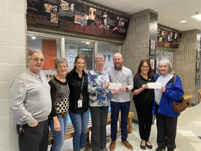 Members of Cedar Crossing, Delhi Friendship Centre, Simcoe Seniors' Centre, and Norfolk County staff smile to receive cheque donation 