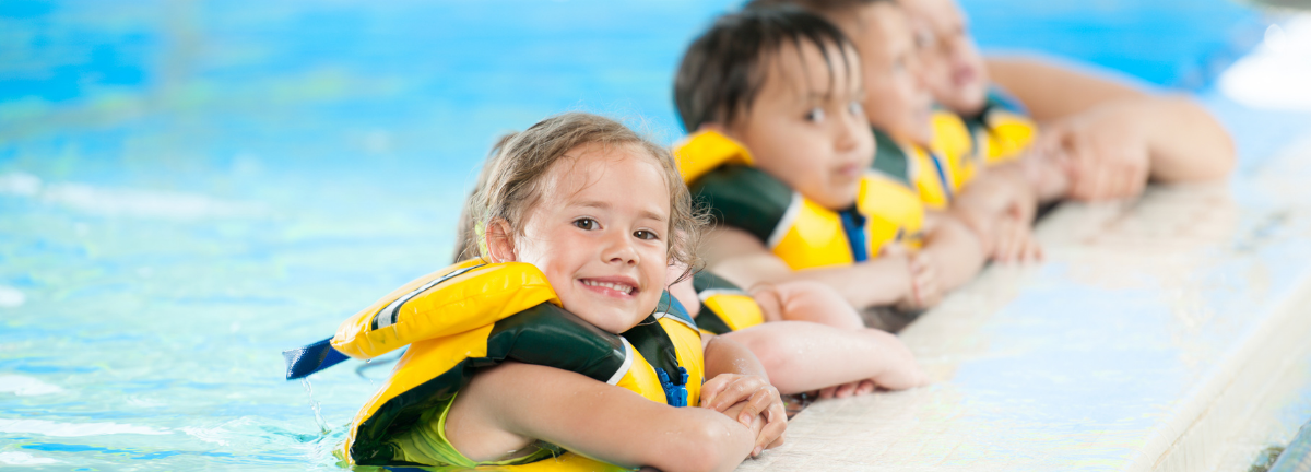 Swimming kids in lifejackets
