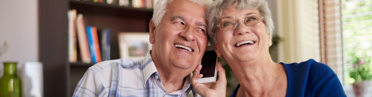 Senior adults smiling while on the phone